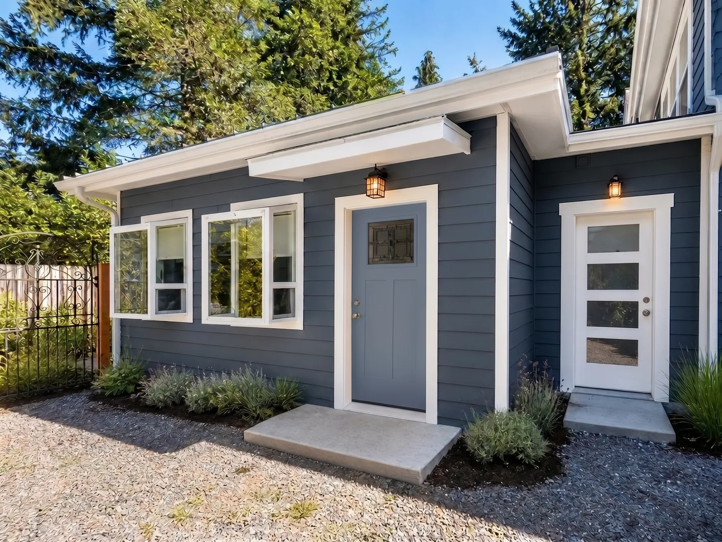 Finished backyard ADU in Bellevue with blue siding and slate blue door