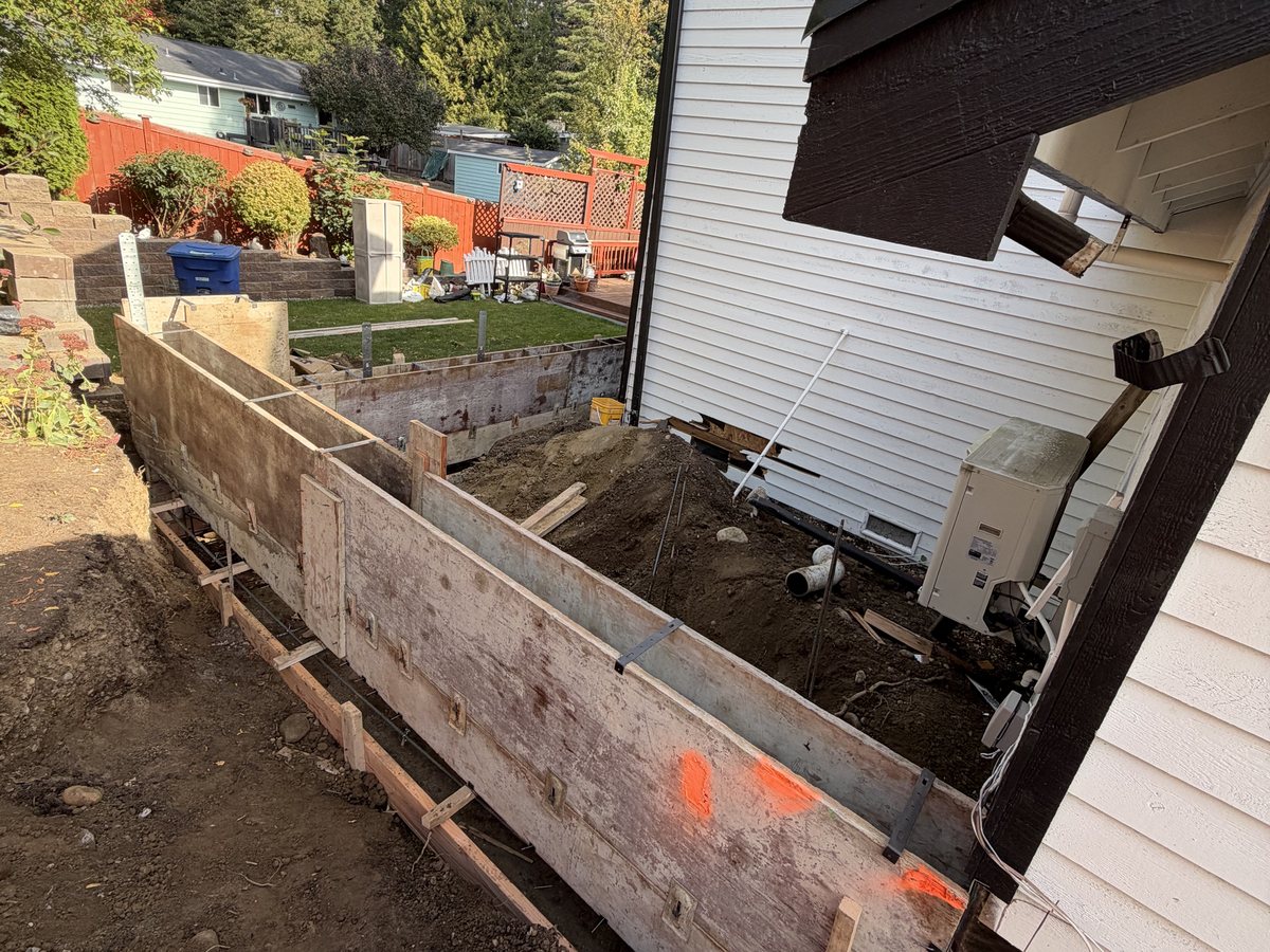 Footing forms along the side of the existing house