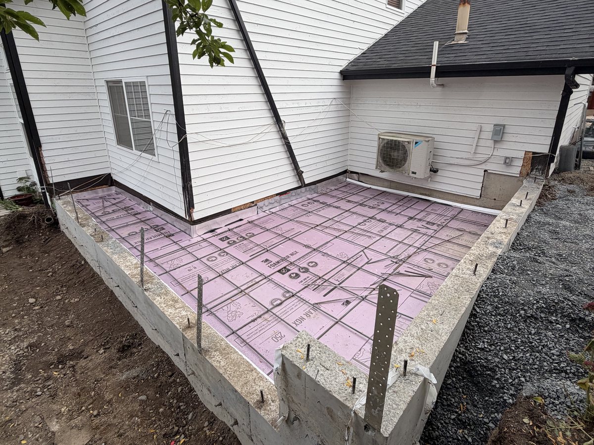 Stem walls with rigid insulation and rebar ready for the slab