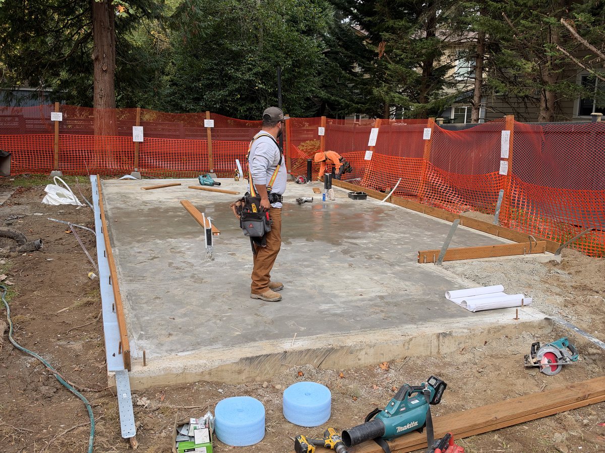 Framer laying out sill plates on the slab