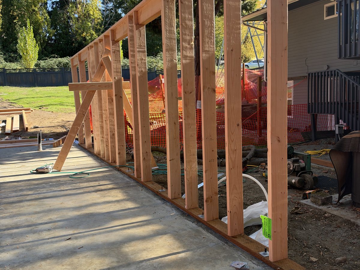 First framed wall standing on the slab