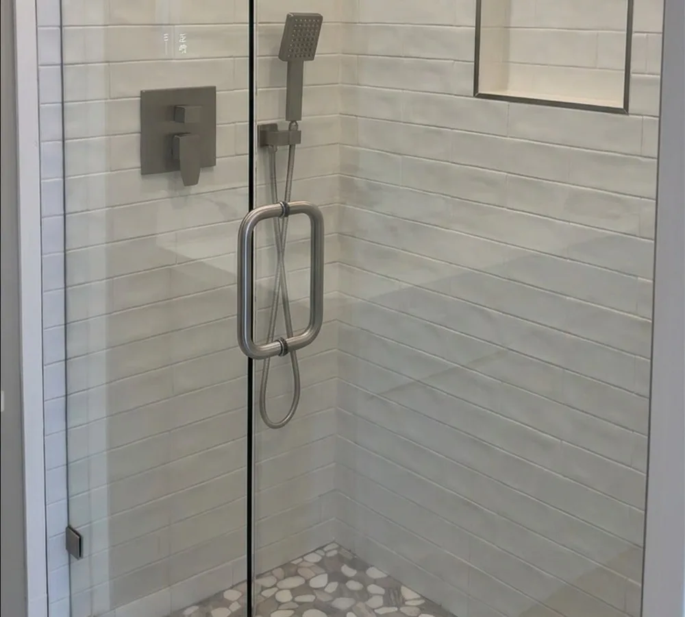 Spa shower with pebble stone pan and glass door in the Magnolia DADU