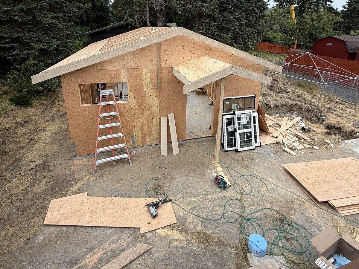 Sheathed ADU with roof deck on and window openings cut